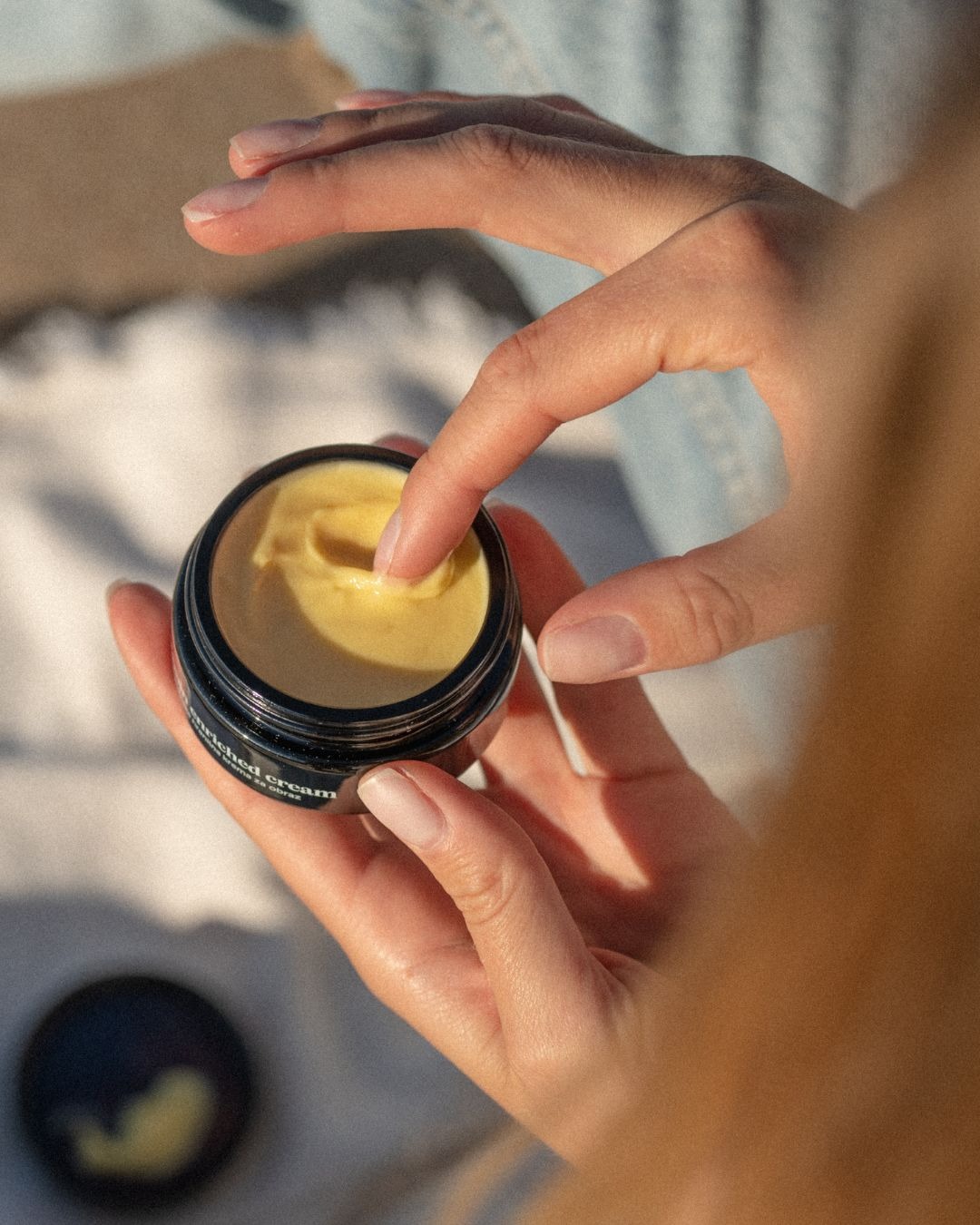 Vitamin Enriched Cream and lady using it 